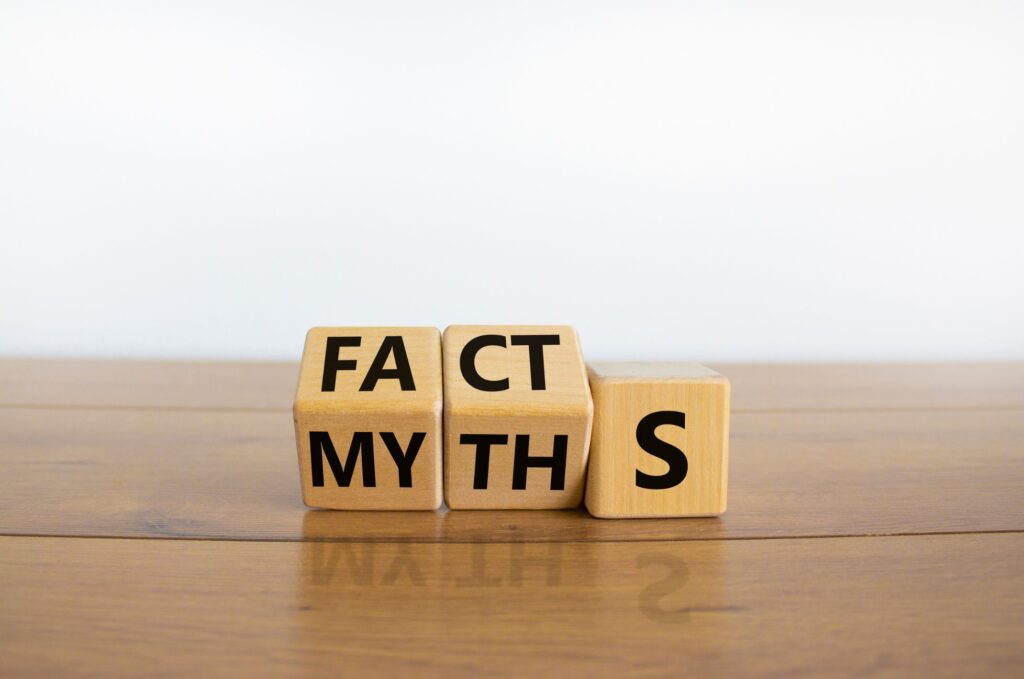 Three dice showing facts and myths word