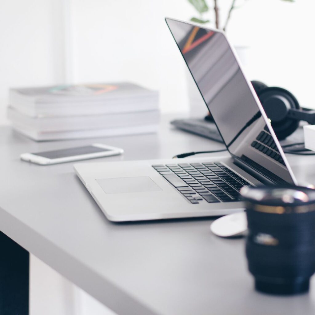 Laptop mobile phone and mug on a desk