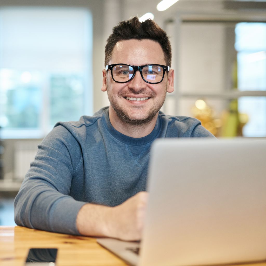 Office employee smiling at the camera